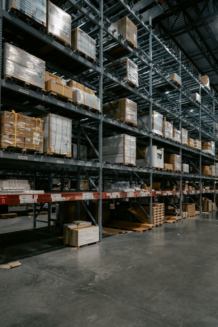 creative-01 A well-organized industrial warehouse with stacked shelves and various pallets for efficient storage.