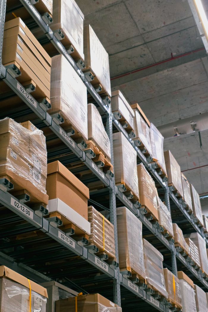 creative-03 A warehouse showcasing organized shelves with stacked cardboard boxes for storage and logistics.